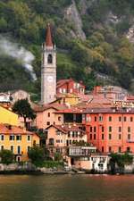 Riverside View of a Charming Clock Tower and Village in Italy in the Summertime Journal