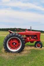 A Bright Red Tractor on a Farm in Delaware USA Journal